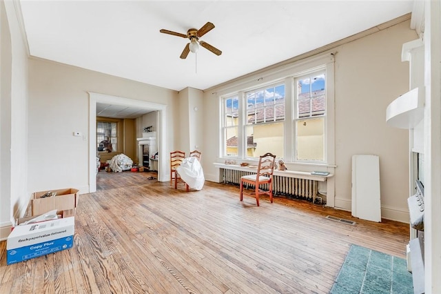 43-45 Union St, Uniontown, PA 15401 - sitting room with baseboards, a fireplace, a ceiling fan, visible vents, and wood finished floors