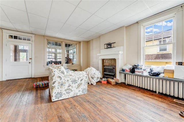 43-45 Union St, Uniontown, PA 15401 - living area featuring a wealth of natural light, a tile fireplace, hardwood / wood-style flooring, and radiator heating unit