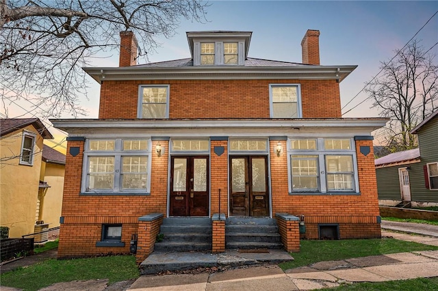 43-45 Union St, Uniontown, PA 15401 - view of front of house with entry steps, french doors, brick siding, and a chimney