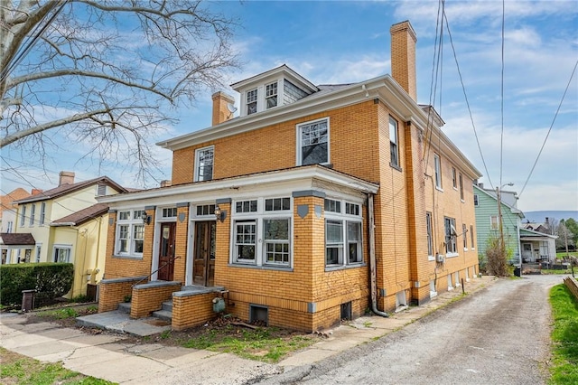 43-45 Union St, Uniontown, PA 15401 - traditional style home featuring brick siding and a chimney