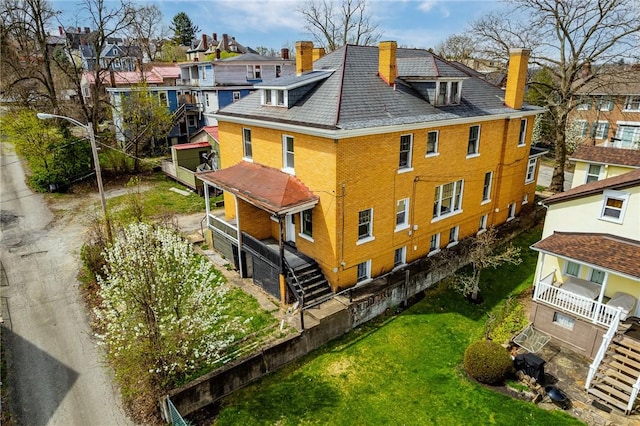 43-45 Union St, Uniontown, PA 15401 - view of property exterior with a chimney, a residential view, and brick siding