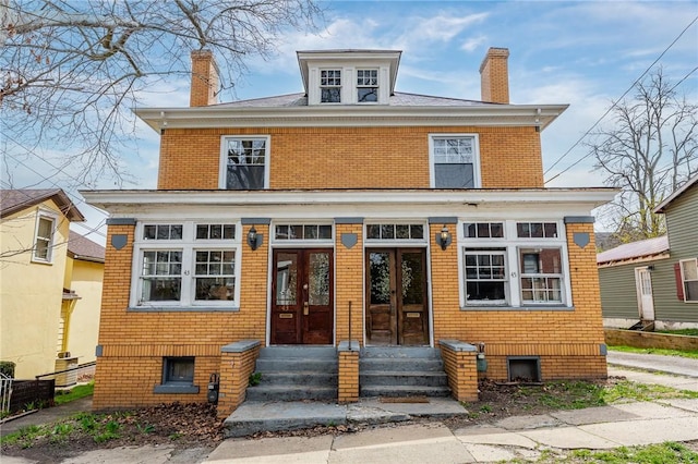 43-45 Union St, Uniontown, PA 15401 - traditional style home with a chimney, entry steps, french doors, and brick siding