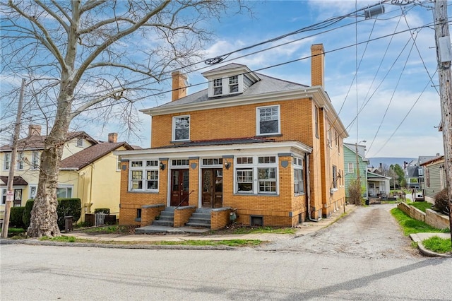 43-45 Union St, Uniontown, PA 15401 - traditional style home with brick siding, driveway, a chimney, and entry steps