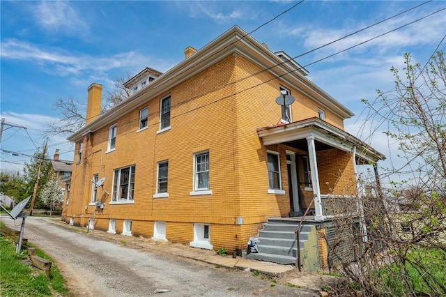 43-45 Union St, Uniontown, PA 15401 - view of side of home featuring brick siding and a chimney