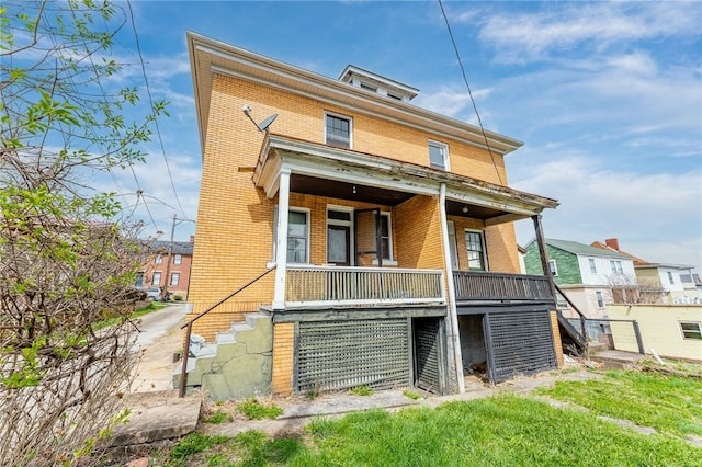 43-45 Union St, Uniontown, PA 15401 - rear view of house featuring brick siding, a porch, and stairs
