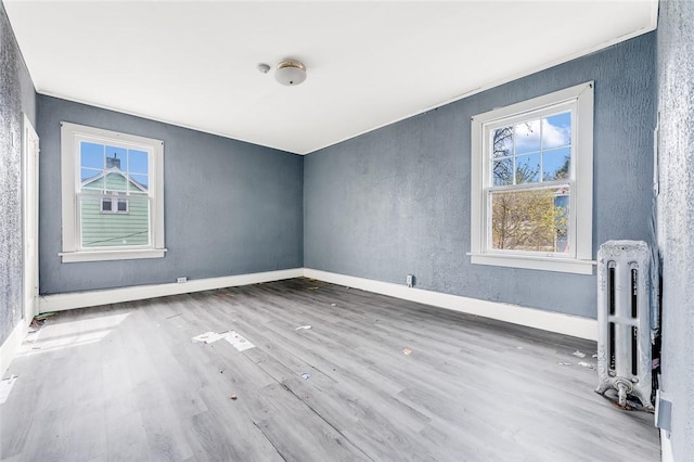 43-45 Union St, Uniontown, PA 15401 - additional living space featuring wood finished floors, radiator heating unit, baseboards, and a textured wall