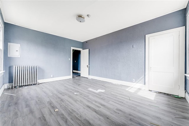 43-45 Union St, Uniontown, PA 15401 - empty room featuring a textured wall, baseboards, radiator, and wood finished floors