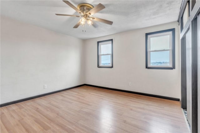 2444 Dewey St, Homestead, PA 15120 - spare room with ceiling fan, light wood finished floors, and baseboards