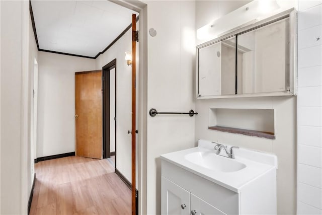 2444 Dewey St, Homestead, PA 15120 - bathroom with crown molding, baseboards, vanity, and wood finished floors