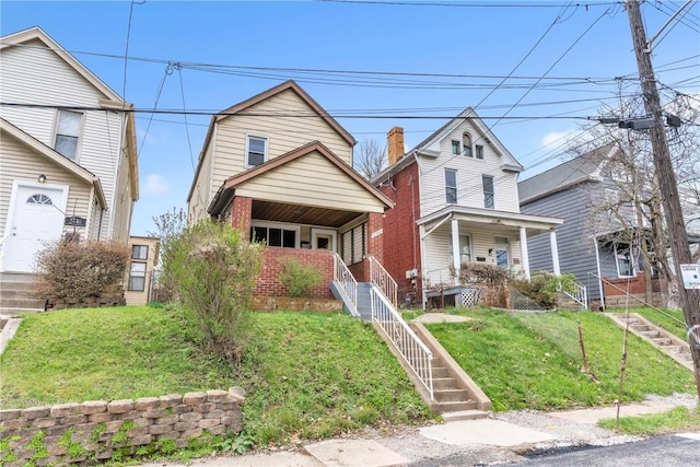 2444 Dewey St, Homestead, PA 15120 - view of front of home with stairway, a front yard, and a porch