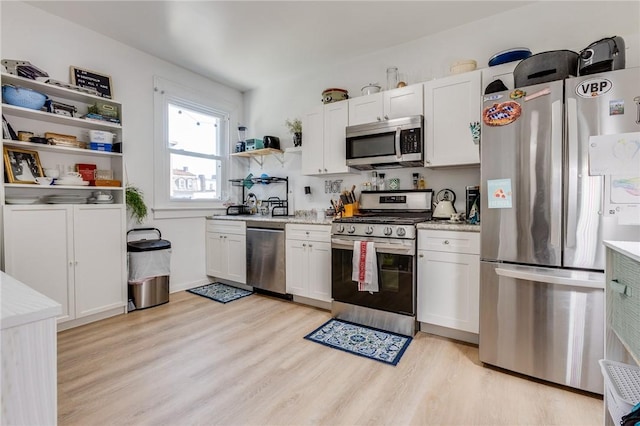 1415 Lager St, Troy Hill, PA 15212 - kitchen featuring white cabinetry, light wood-type flooring, open shelves, and stainless steel appliances