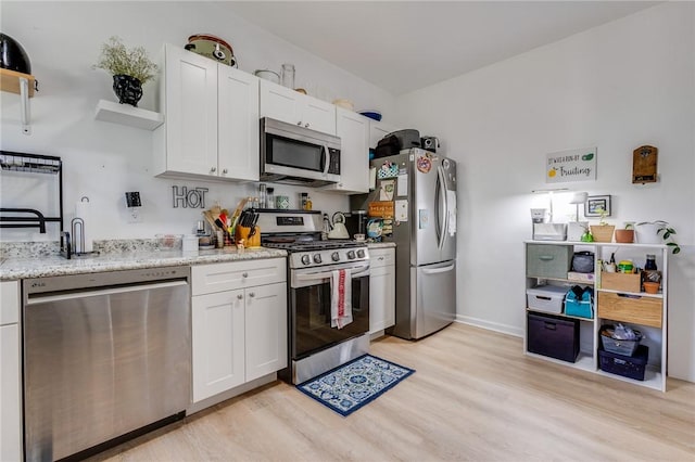 1415 Lager St, Troy Hill, PA 15212 - kitchen with white cabinetry, open shelves, light wood-type flooring, and appliances with stainless steel finishes