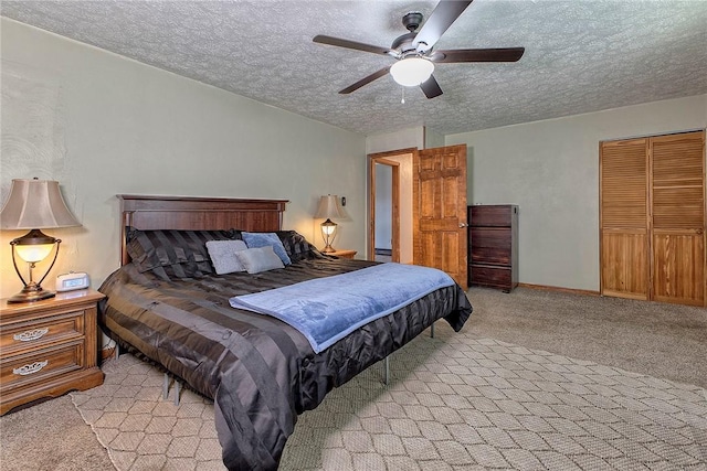 bedroom featuring light colored carpet, a textured ceiling, and ceiling fan