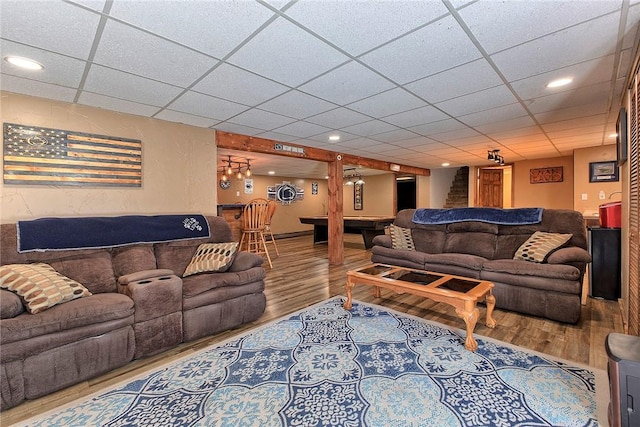 living area featuring billiards, recessed lighting, a bar, a drop ceiling, and wood finished floors