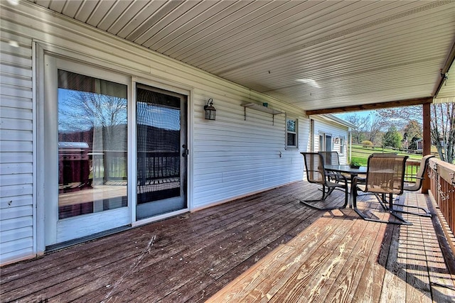 wooden deck featuring outdoor dining area and area for grilling