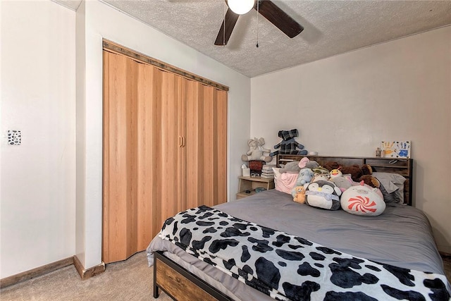 bedroom featuring baseboards, a ceiling fan, light colored carpet, and a textured ceiling