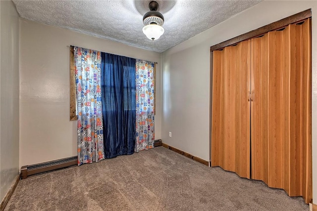 unfurnished bedroom with baseboards, light colored carpet, and a textured ceiling