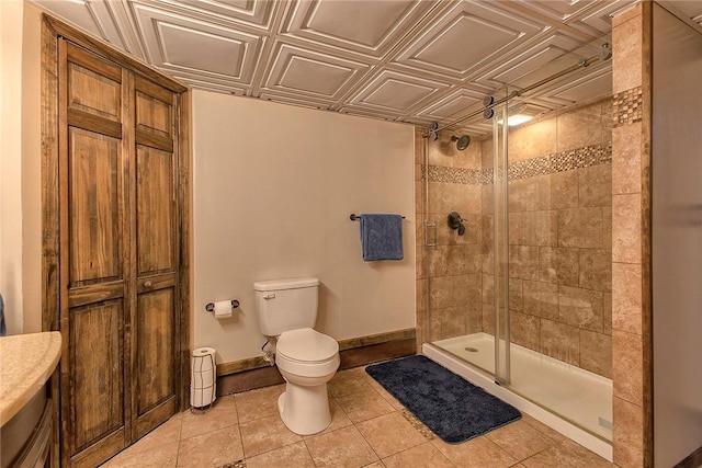 full bath with baseboards, a stall shower, tile patterned flooring, toilet, and an ornate ceiling