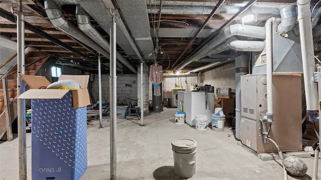 unfinished basement featuring water heater and washer / dryer
