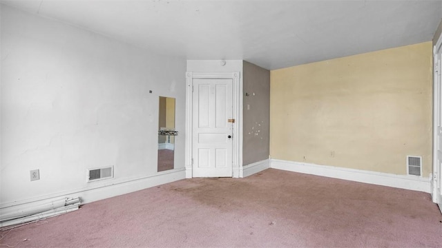 empty room with visible vents, baseboards, and carpet floors