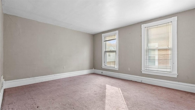 carpeted spare room with baseboards