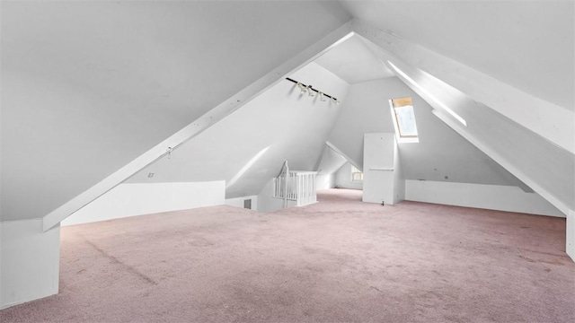 additional living space featuring carpet floors and vaulted ceiling