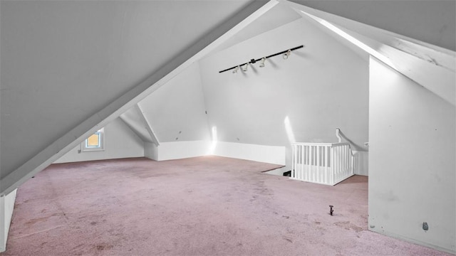 additional living space featuring carpet flooring and lofted ceiling