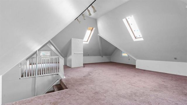 bonus room with vaulted ceiling with skylight, carpet, and a wealth of natural light