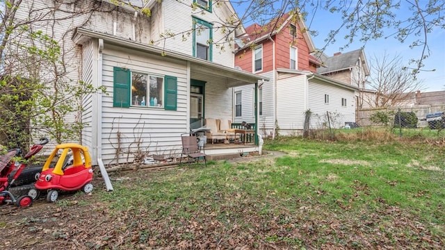 rear view of house featuring a lawn