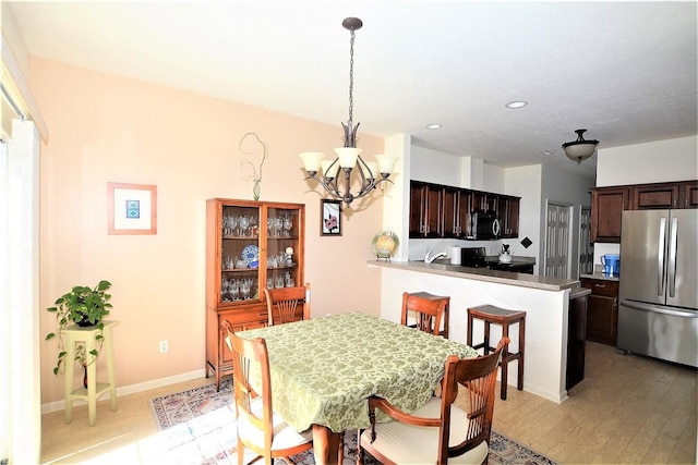 513 Madison Blvd, New Sewickley Twp, PA 15042 - dining area featuring light wood-style flooring, a notable chandelier, and recessed lighting