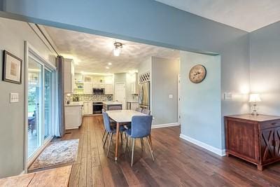 dining area with baseboards and dark wood-style floors