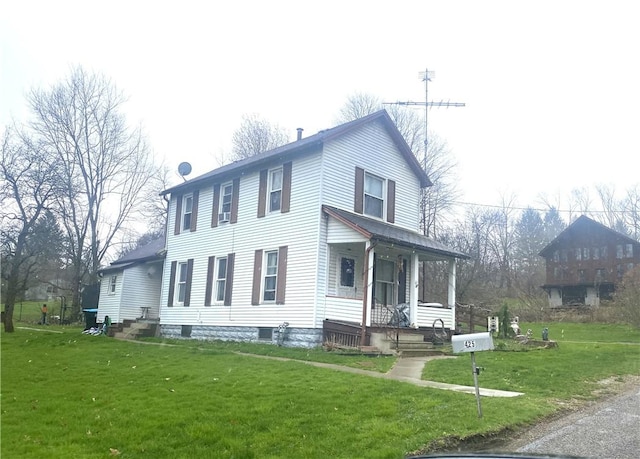view of front of home featuring a front yard and covered porch
