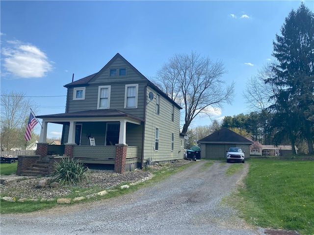 view of front of house featuring an outdoor structure, a porch, a front yard, and a garage