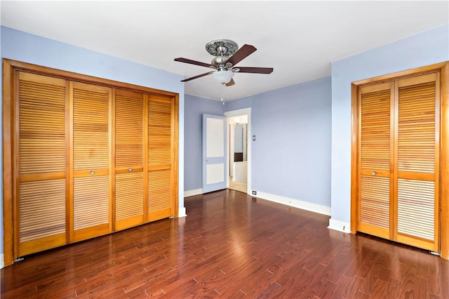 unfurnished bedroom featuring a closet, baseboards, ceiling fan, and dark wood-style floors