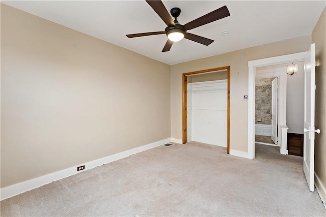 unfurnished bedroom with light carpet, a closet, ceiling fan, and baseboards