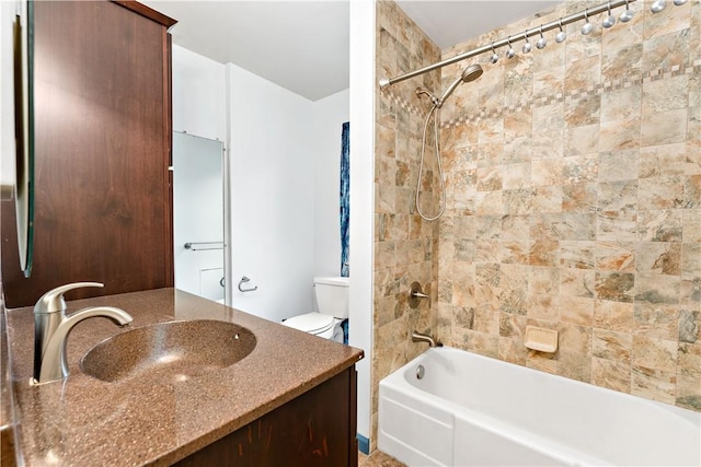 bathroom featuring toilet, vanity, and shower / bathing tub combination