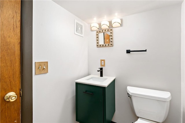 bathroom with vanity, visible vents, and toilet