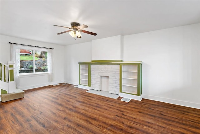 unfurnished living room with a fireplace with flush hearth, ceiling fan, baseboards, and wood finished floors