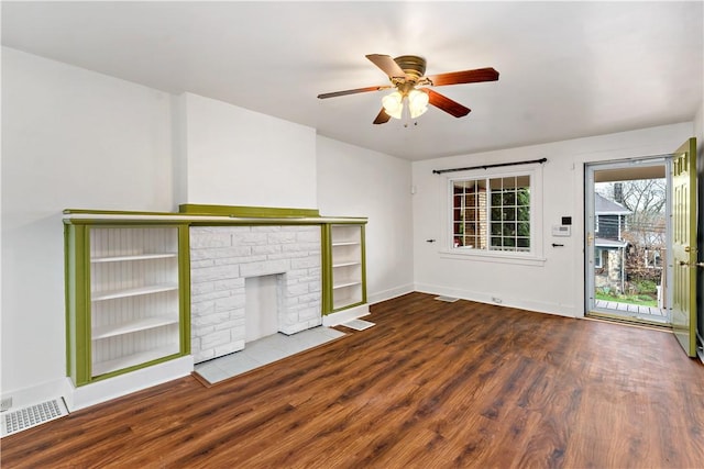unfurnished living room with visible vents, ceiling fan, baseboards, and wood finished floors