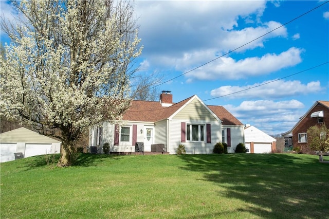 429 Big Knob Rd, New Sewickley Twp, PA 15074 - bungalow featuring a chimney, a detached garage, a front lawn, and central AC