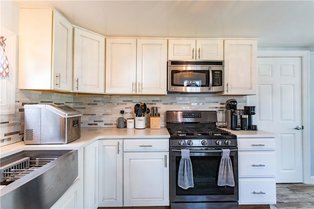 429 Big Knob Rd, New Sewickley Twp, PA 15074 - kitchen with light countertops, backsplash, white cabinets, and stainless steel appliances