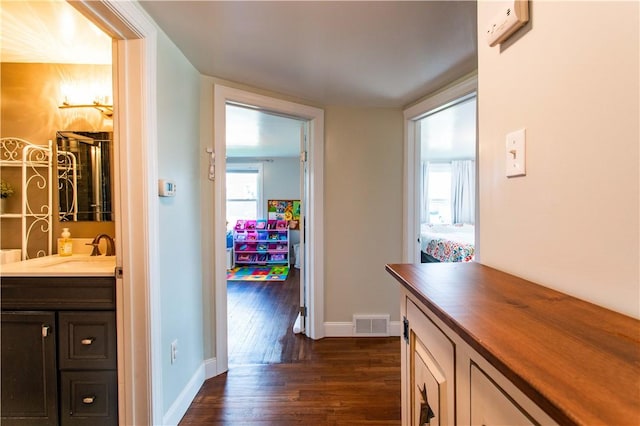 429 Big Knob Rd, New Sewickley Twp, PA 15074 - corridor featuring baseboards, dark wood-style floors, visible vents, and a sink