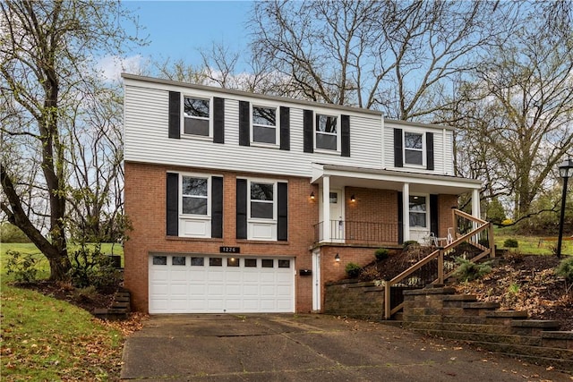 1226 Lamson Cir, Upper St Clair, PA 15241 - view of front facade featuring stairway, driveway, an attached garage, a porch, and brick siding