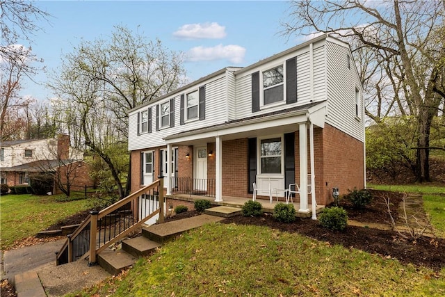 1226 Lamson Cir, Upper St Clair, PA 15241 - view of front of property with brick siding, a front yard, and covered porch