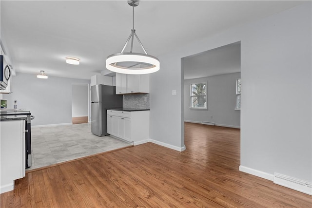 1226 Lamson Cir, Upper St Clair, PA 15241 - kitchen featuring baseboards, range with electric cooktop, dark countertops, freestanding refrigerator, and light wood-style flooring