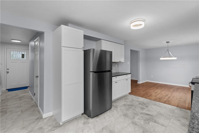 1226 Lamson Cir, Upper St Clair, PA 15241 - kitchen with white cabinetry, baseboards, freestanding refrigerator, and dark countertops