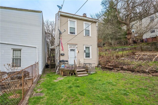 203 57th St, Lawrenceville, PA 15201 - back of property featuring a yard, fence, and a chimney