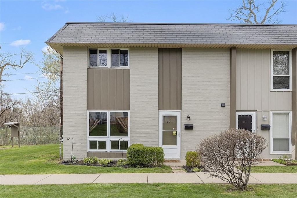 101 College Park Dr, Moon/Crescent Twp, PA 15108 - view of front of property featuring board and batten siding, a front lawn, and brick siding