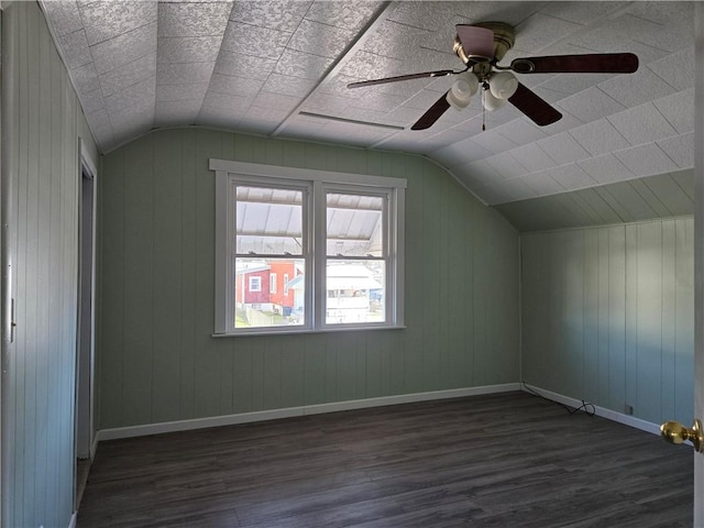 additional living space featuring baseboards, dark wood-style flooring, ceiling fan, and lofted ceiling