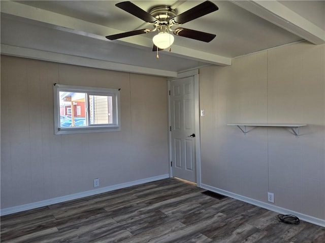spare room with baseboards, dark wood-style floors, visible vents, beam ceiling, and ceiling fan